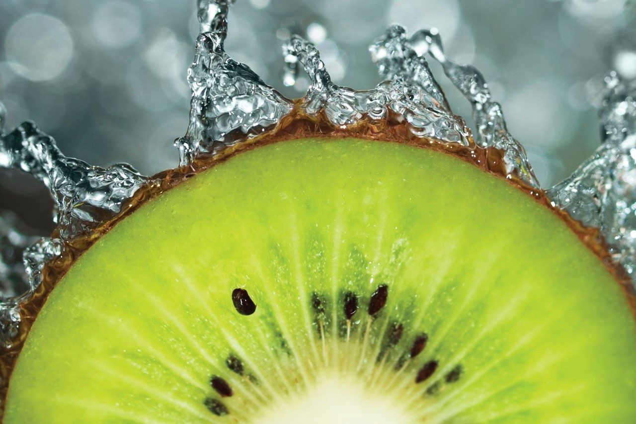 Kiwi slice splashing in water