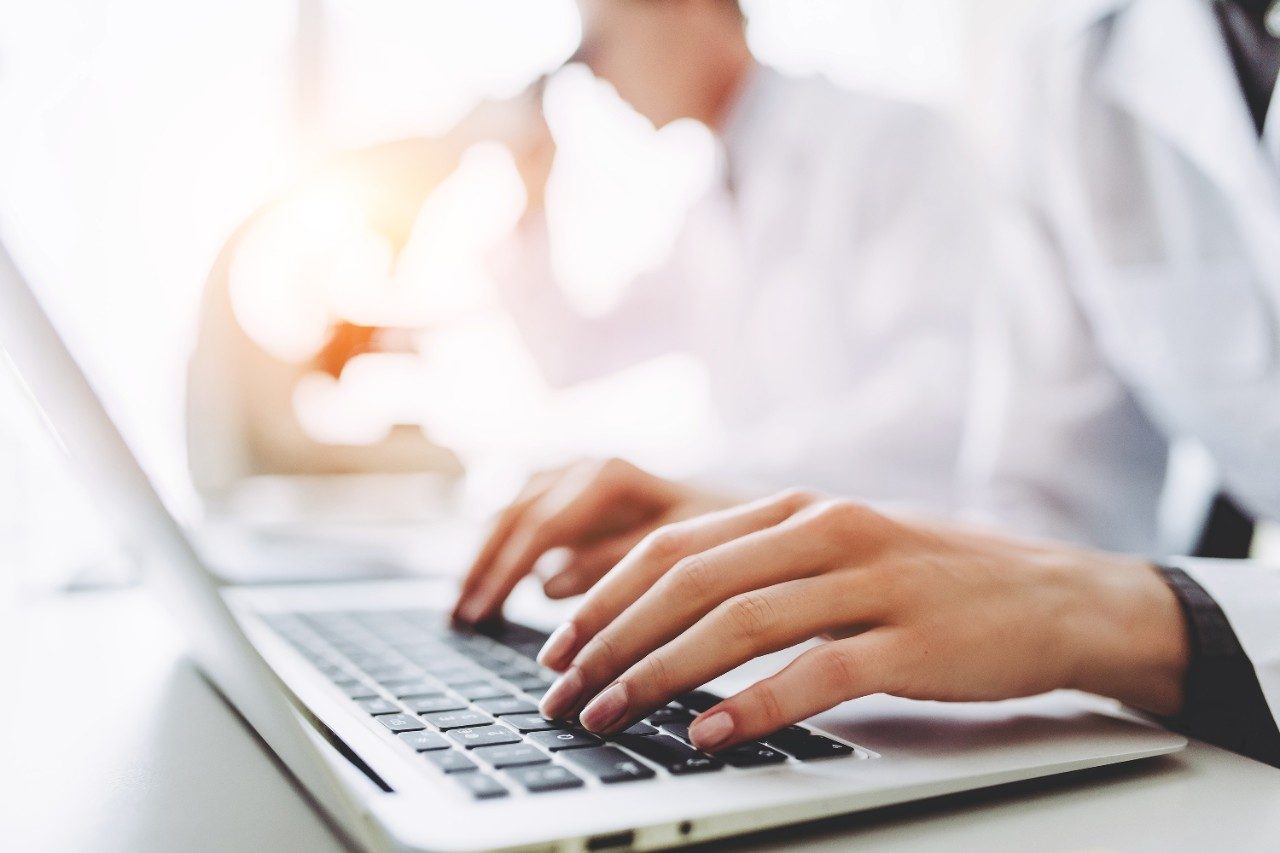 Scientists in lab using laptop