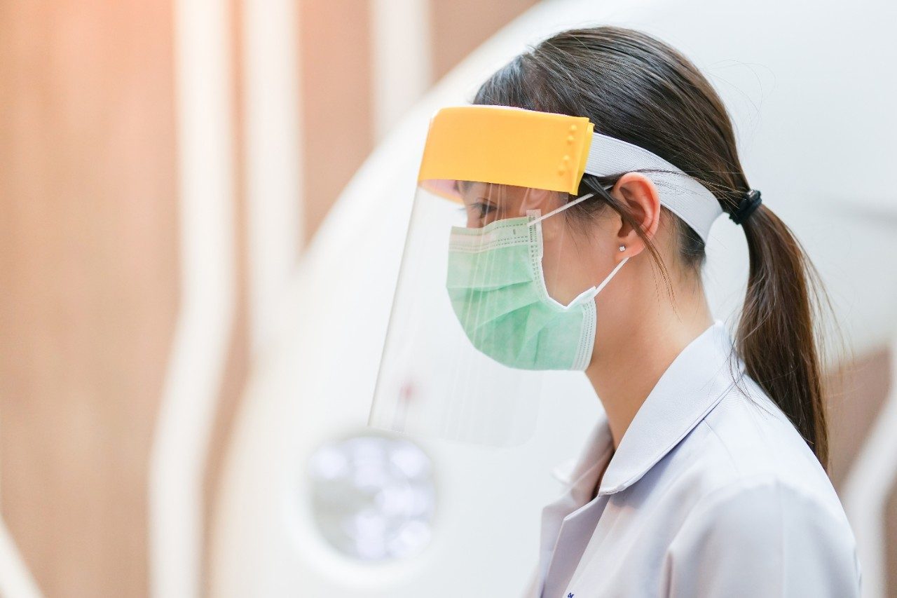 Medical staff wearing face shield and mask for coronavirus covid-19 ppe protection 